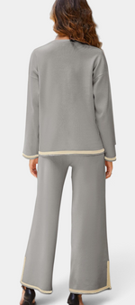 Back view of Mahaute Ysella grey knit lounge set with long sleeve top and wide leg trousers with contrast trim