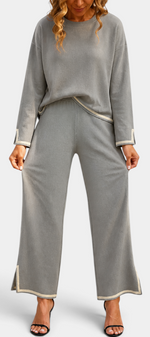 Mahaute Ysella grey knit lounge set with loose long-sleeve top and wide-leg trousers featuring contrast trim details.