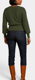 Mahaute Zia olive green knit wrap sweater with long puff sleeves worn with dark denim jeans and brown boots