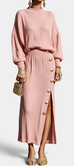 Mahaute Zornitsa pink pleated two-piece set featuring a fluid blouse and a long skirt with gold button side slit.