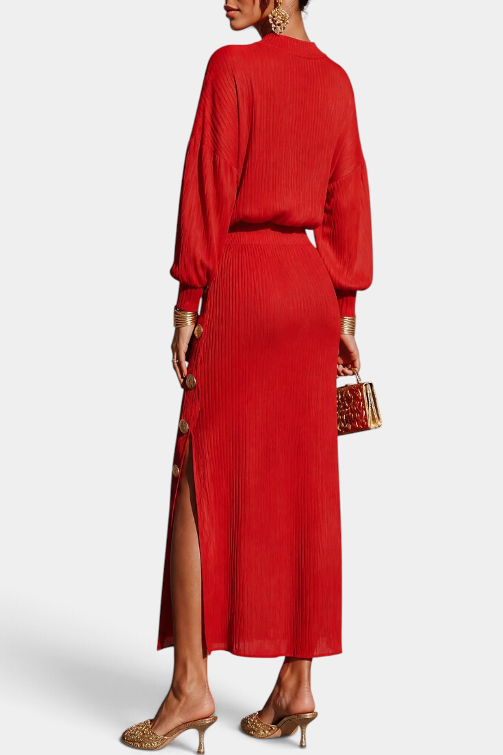Mahaute Zornitsa red pleated two-piece set featuring a fluid blouse and a long skirt with gold button side slit